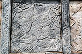 Bangkok Wat Pho. Around the base of the ubosot are 152 stone panels with bas-reliefs which narrate the story of the Ramakien, Thai version of the Hindu Ramayama. 